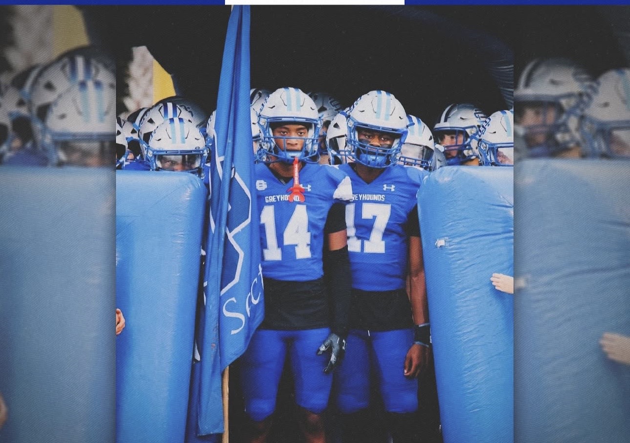 Nolan Wells standing with a teammate before a football game
